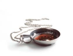 Tastevin it is a silver made ashtray like bowl many Sommeliers or wine servers in high end restaurants wear around their necks It is a wine-tasting cup an old or per say ancient tasting tool that was used in the old days to taste teh clarity of hte wine in cellars its called Tastevin pronounced Taht-vahN and it means taste wine in english and in spanish para provar el vino it helps check on the clairty and quality of the wine